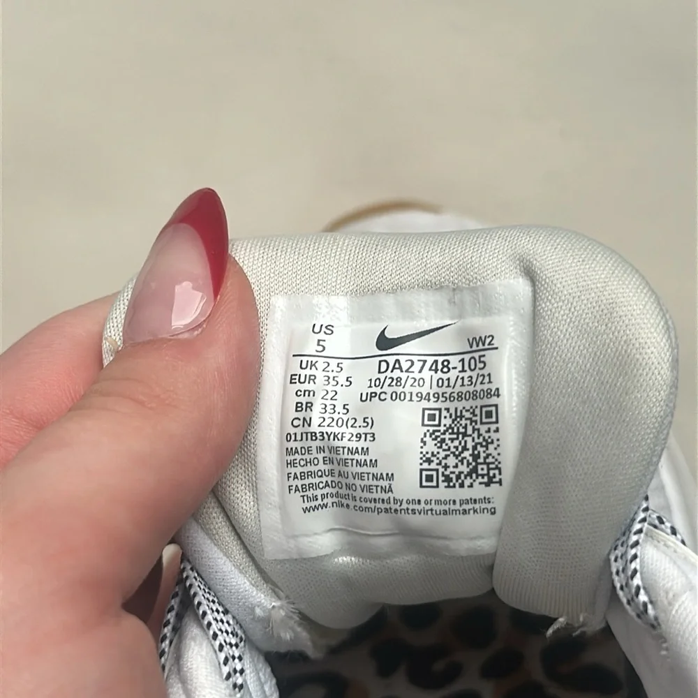 White Nike air max shoes, size 5 with gold Nike embroidering/cheetah print heal